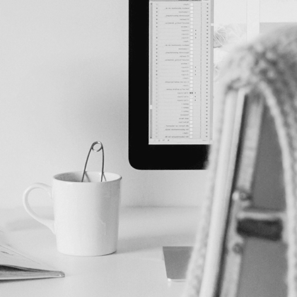 A comfortable desk and chair with a cup of tea